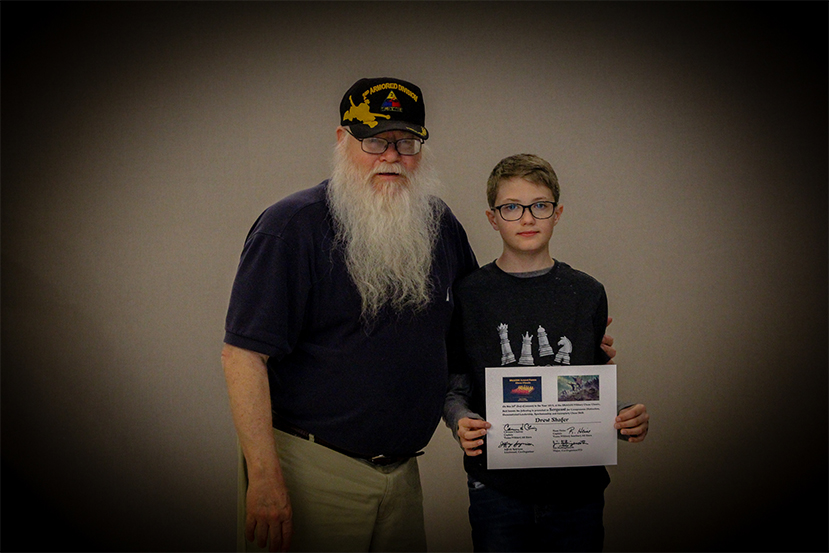 Jim Hollingsworth (left) promoting Drew Shafer (right) to Sergeant in the Texas Chess Militia.